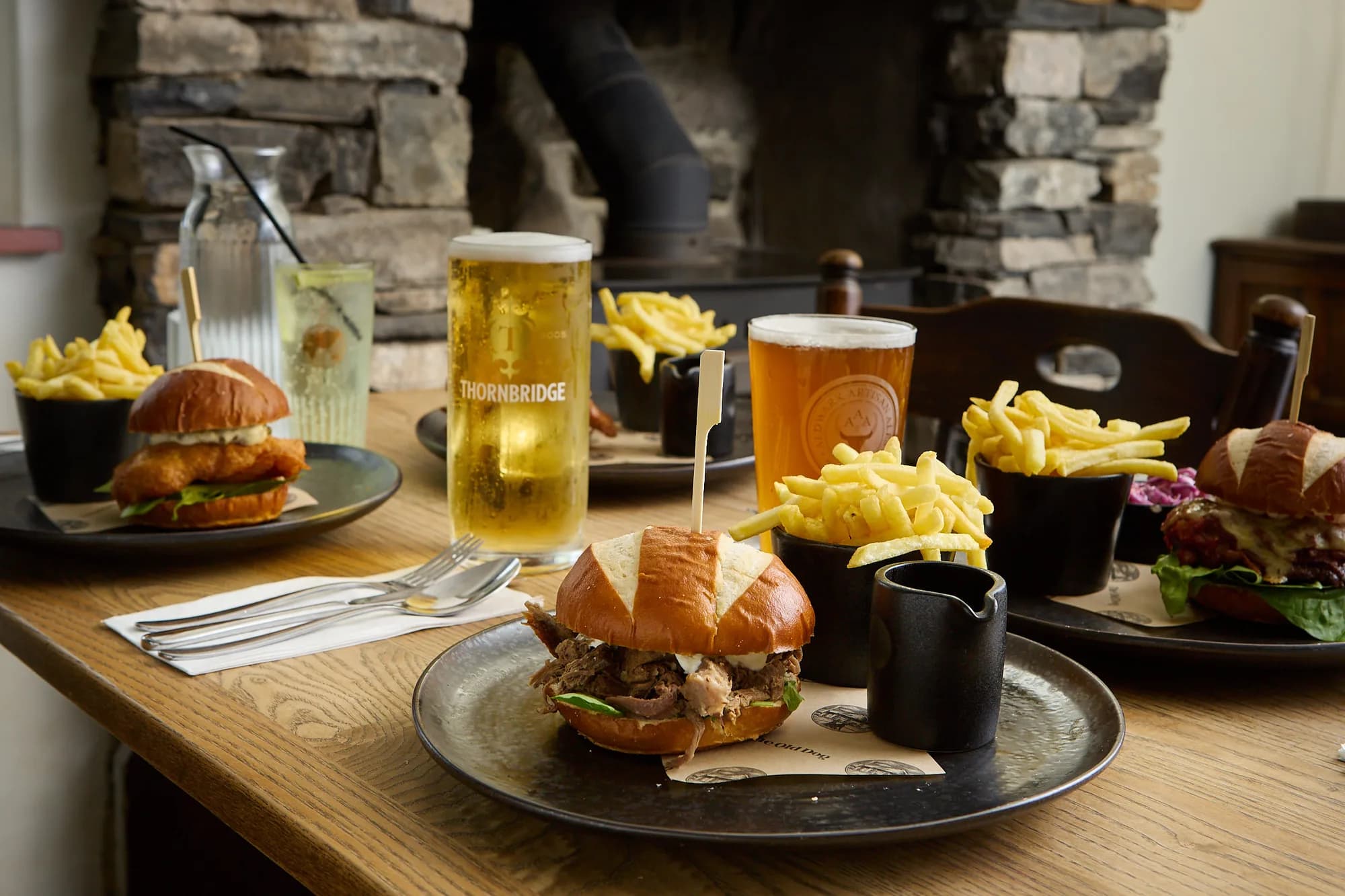 Burgers, chips and pints on a table at The Old Dog