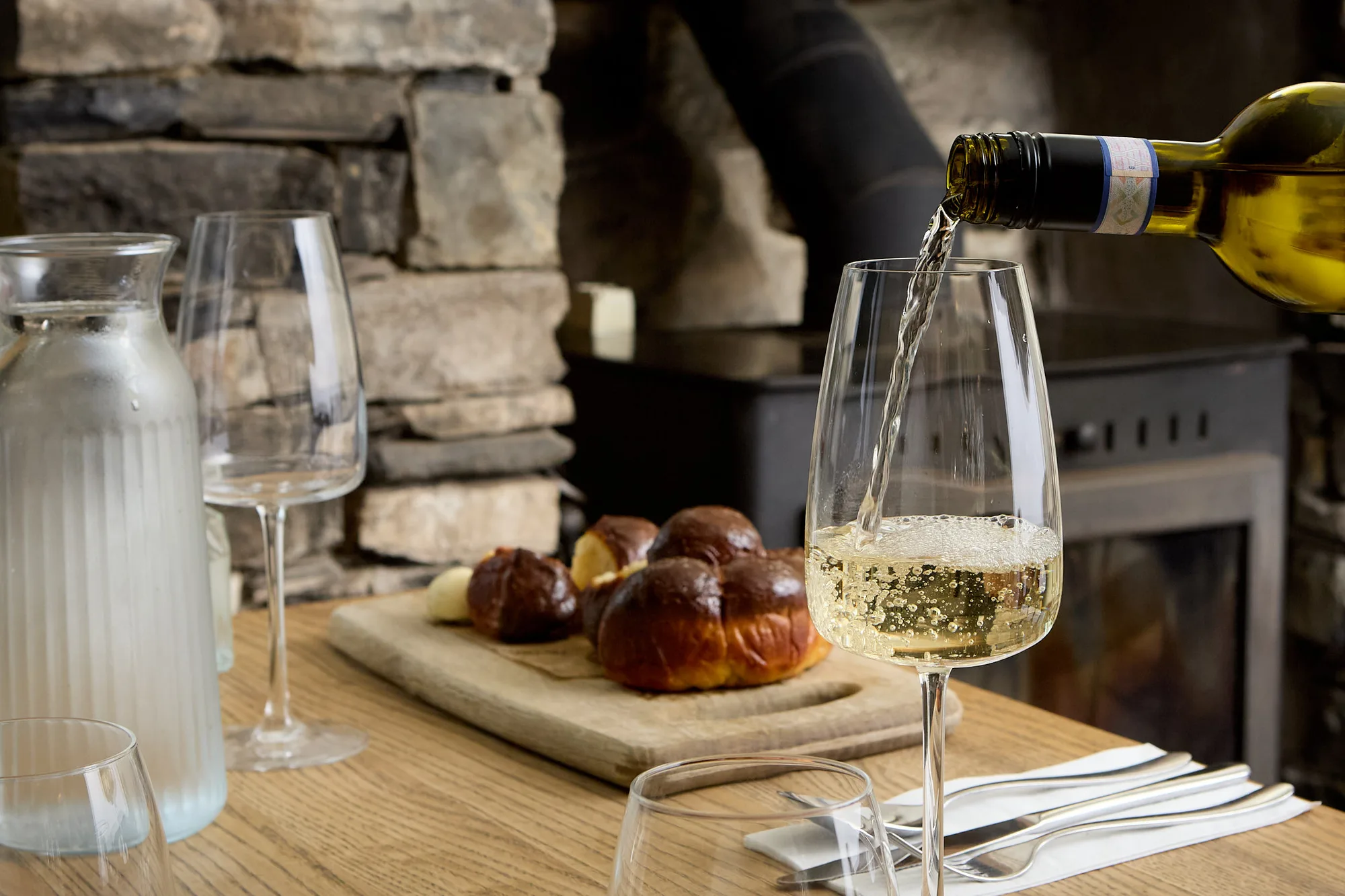 White wine being poured beside bread and butter at The Old Dog